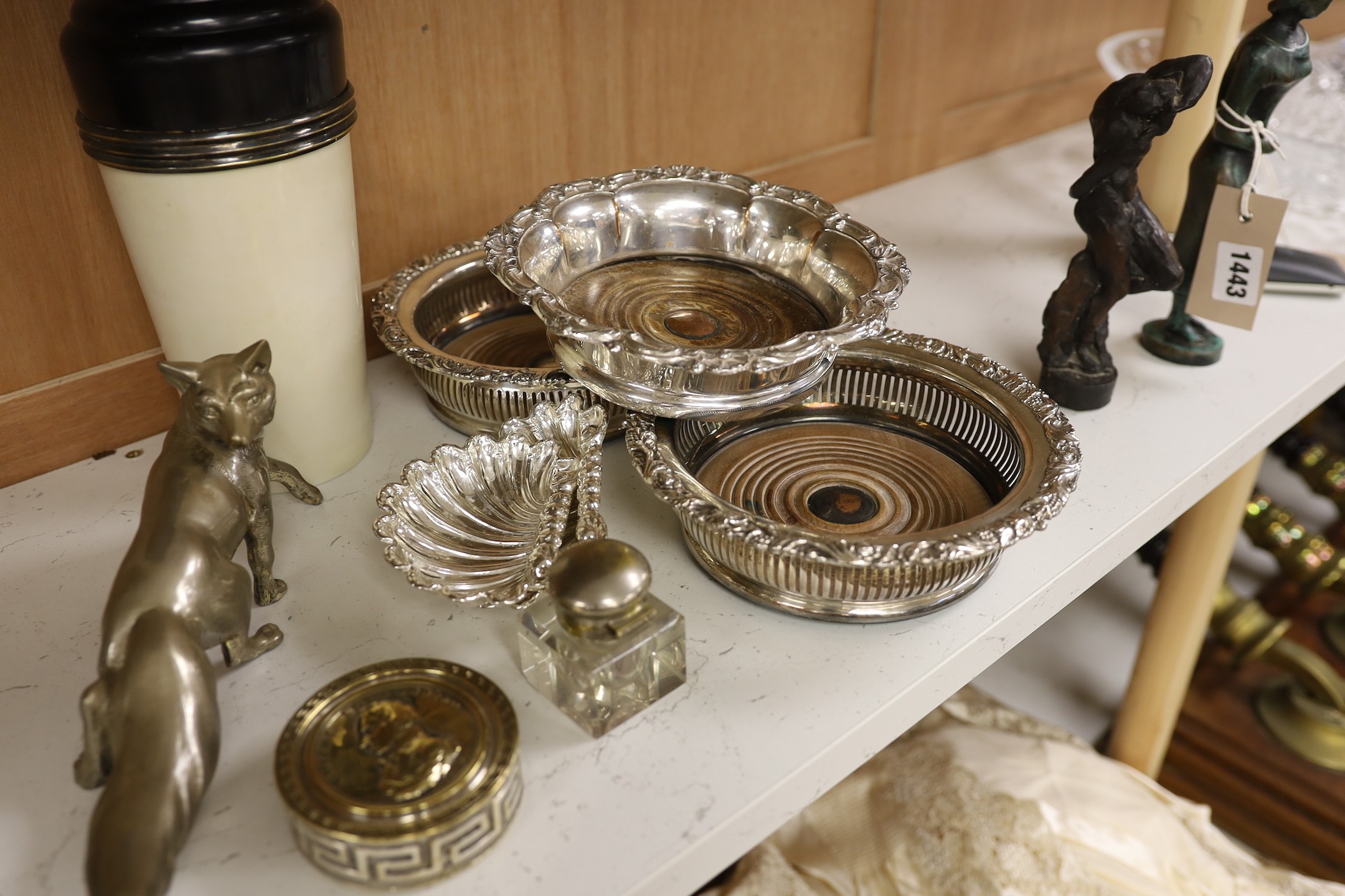 Three silver plated wine coasters, a pair of shell butter dishes, fox, ink well and a cocktail shaker